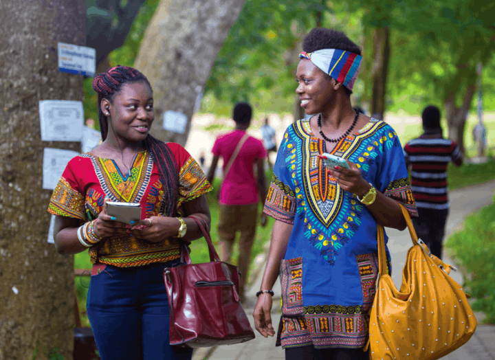 Two female students have conversation on their way to class